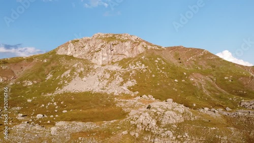 Mountain landscape in summer, aerial drone view. Bare Mountain Range in Nature. Hills, rocks, slopes and pasture. Dinaric Alps, Visocica, Bosnia and Herzegovina. photo