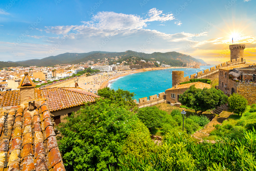 View from the 12th century medieval castle along the Costa Brava coast of the Mediterranean sea, sandy beach, turquoise waters and whitewashed town of Tossa de Mar, Spain.