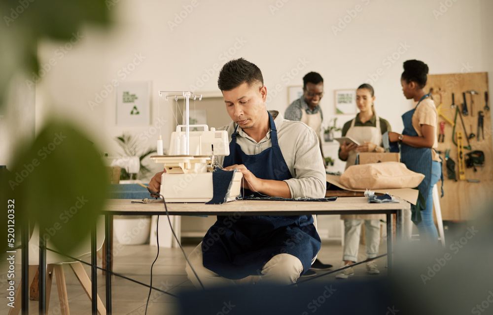 Obraz premium Fashion, design and style with a young designer working in a startup on a sewing machine in a workshop. Busy and creative designer creating new, trendy and fashionable clothes in a small business