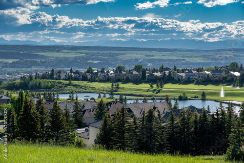 Overlooking a small Alberta town with the Glen Eagles Golf Course and distant Rocky Mountains.