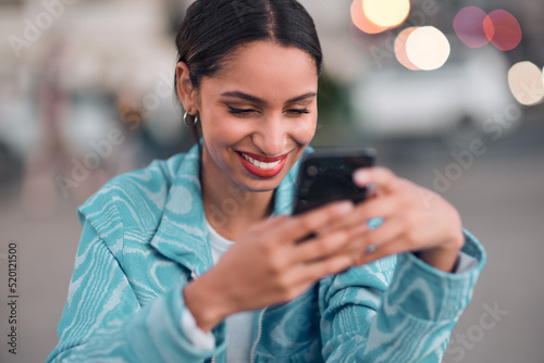 Trendy, happy and modern woman texting on a phone, browsing social media or surfing the internet. Single female looking confident and relaxed, smiling while reading a message on an online dating app