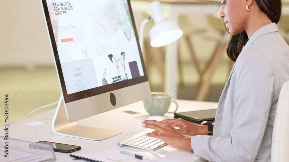 Web or graphic designer typing on a computer and designing a website in her office. Female doing digital creative planning and editing an app layout for better user experience