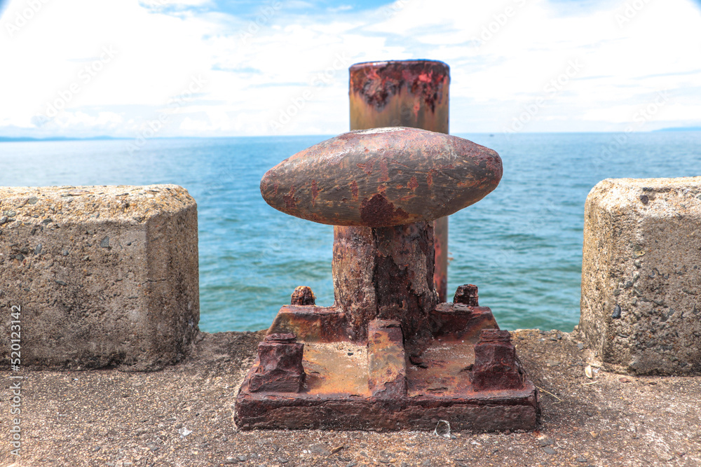 Boat mooring bollard Tourist jetty and local fishing boats, standard,old rusty anchor Boat mooring bollard Tourist jetty and local fishing boats, standard,old rusty anchor