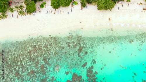 Tropical landscape with a beautiful beach and the blue water. Alorro Beach, Philippines, Samal. photo