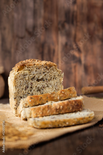 whole wheat baking bread with grains for healthy eating on wood table in kitchen