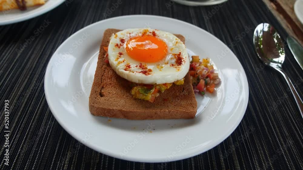 View from above of a toasted whole grain bread with raw vegetables and roasted egg on a white plate in a restaurant menu. Tasty healthy breakfast, snack. Food and drink industry. Consumerism View from above of a toasted whole grain bread with raw vegetables and roasted egg on a white plate in a restaurant menu. Tasty healthy breakfast, snack. Food and drink industry. Consumerism