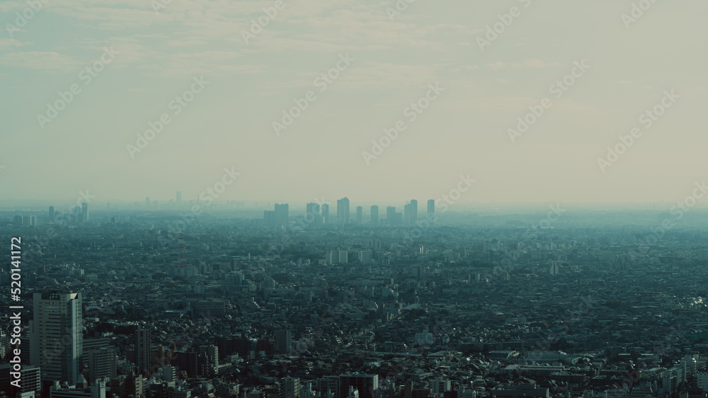 Tokyo cityscape with isolated buildings on a cloudy blue day