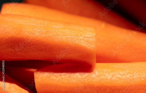 Orange peeled carrots as a background.