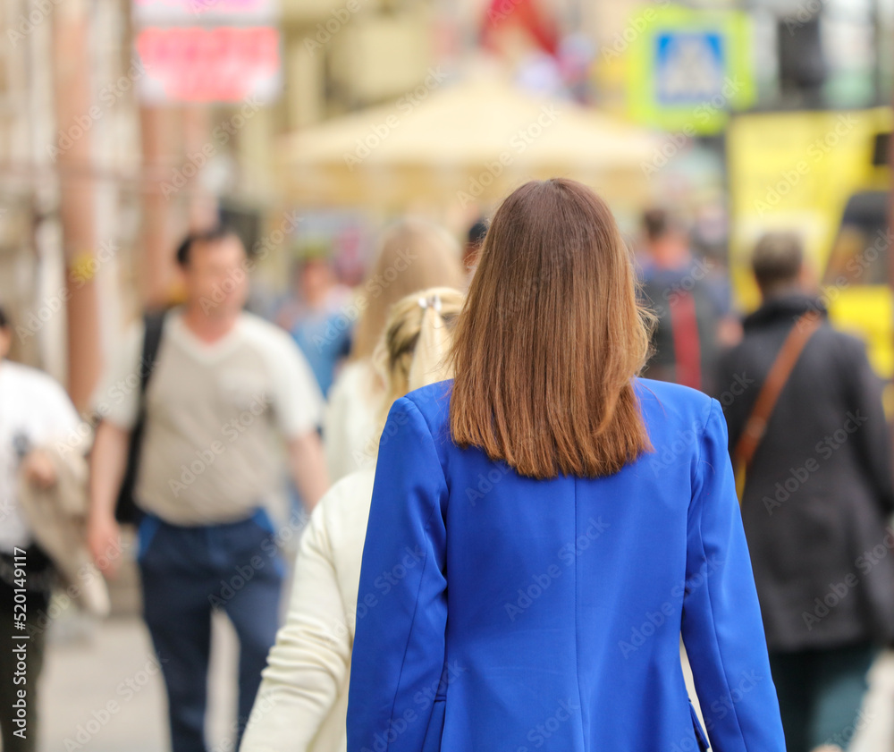 A woman is walking down the street