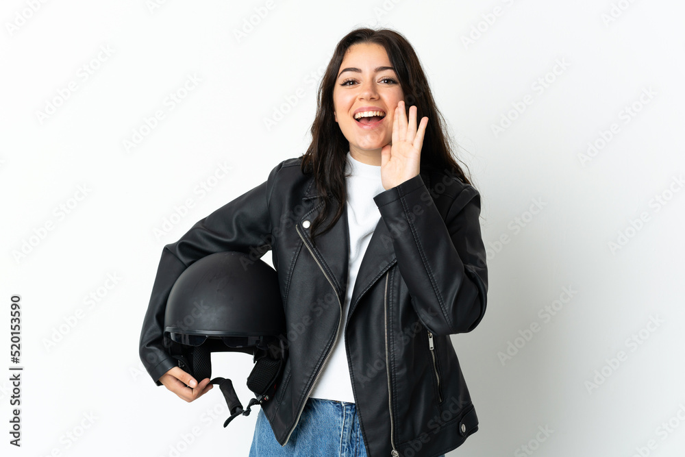 Woman holding a motorcycle helmet isolated on white background shouting with mouth wide open Woman holding a motorcycle helmet isolated on white background shouting with mouth wide open