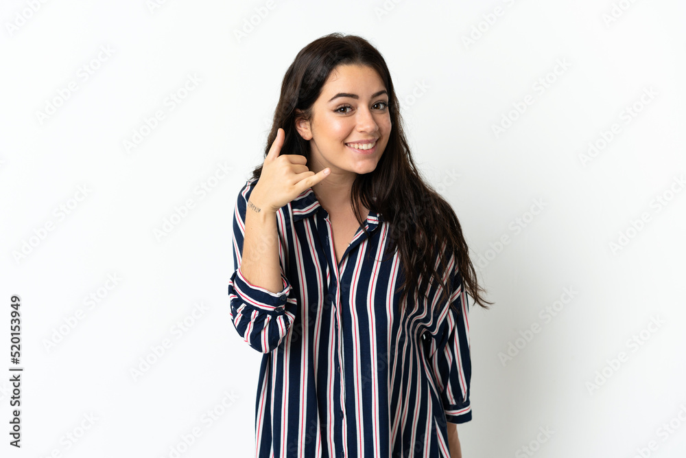 Young caucasian woman over isolated background making phone gesture. Call me back sign Young caucasian woman over isolated background making phone gesture. Call me back sign