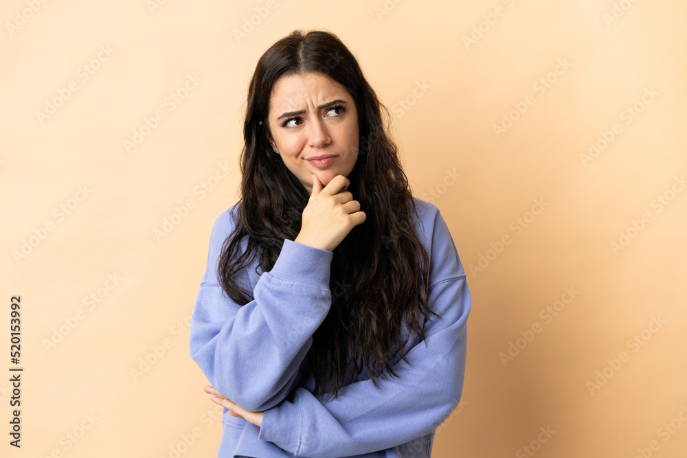 Young caucasian woman over isolated background having doubts Young caucasian woman over isolated background having doubts