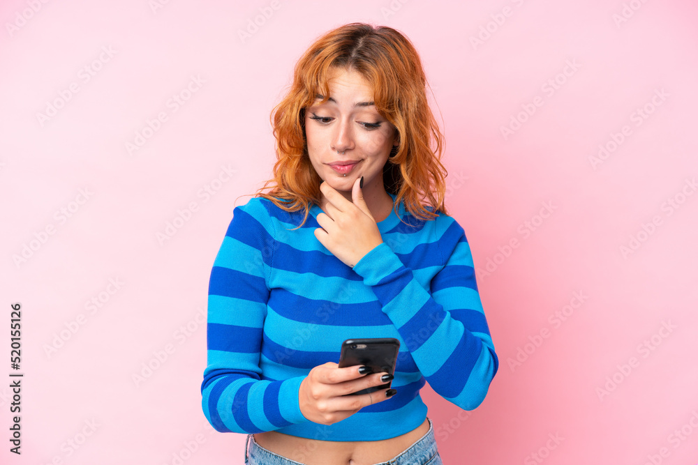 Young caucasian woman isolated on pink background thinking and sending a message Young caucasian woman isolated on pink background thinking and sending a message