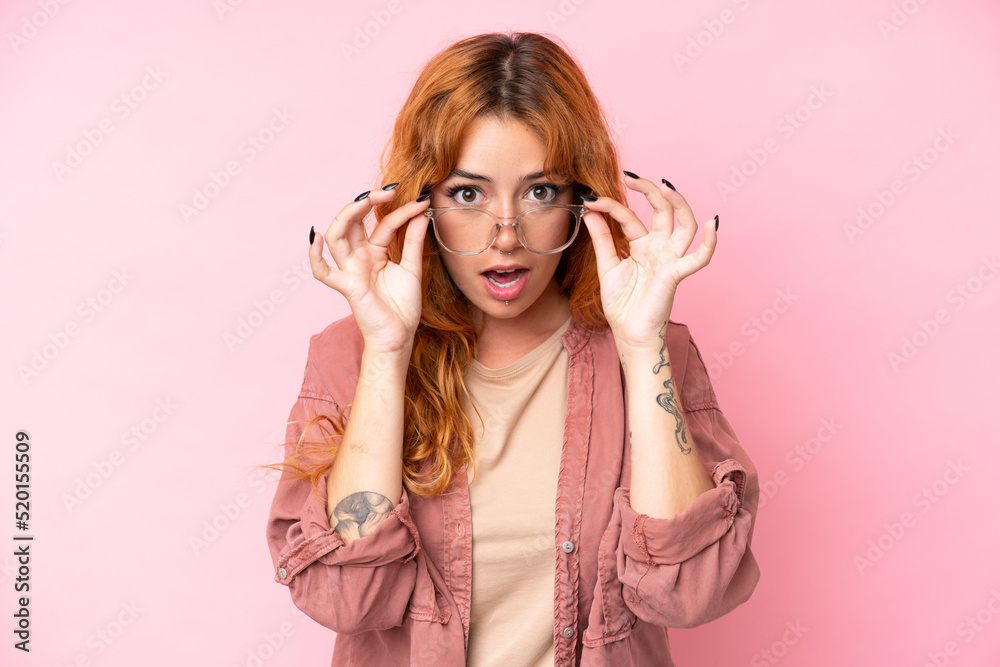 Young caucasian woman isolated on pink background With glasses and surprised expression Young caucasian woman isolated on pink background With glasses and surprised expression