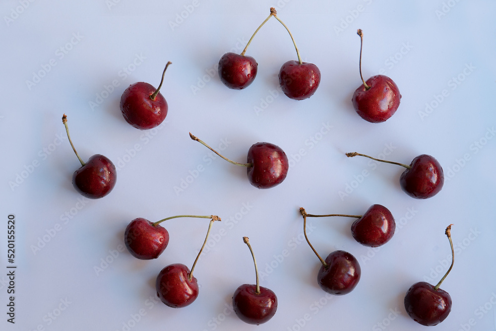 Cherries with a hard shadows randomly placed on a light background Cherries with a hard shadows randomly placed on a light background