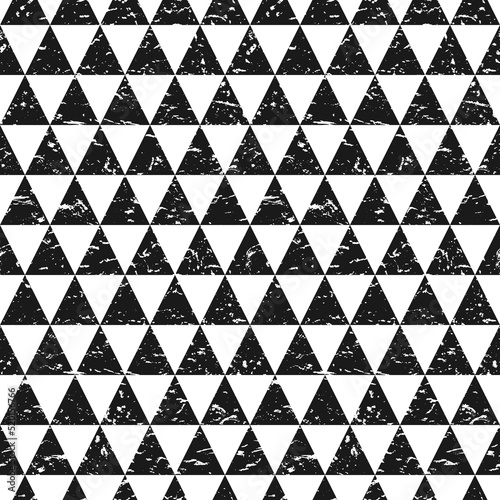 Grunge ornament with black triangles on white background. Scratched geometric seamless texture. modern pattern or wallpaper.