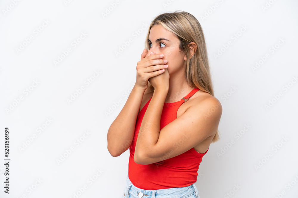 Young caucasian woman isolated on white background covering mouth and looking to the side Young caucasian woman isolated on white background covering mouth and looking to the side