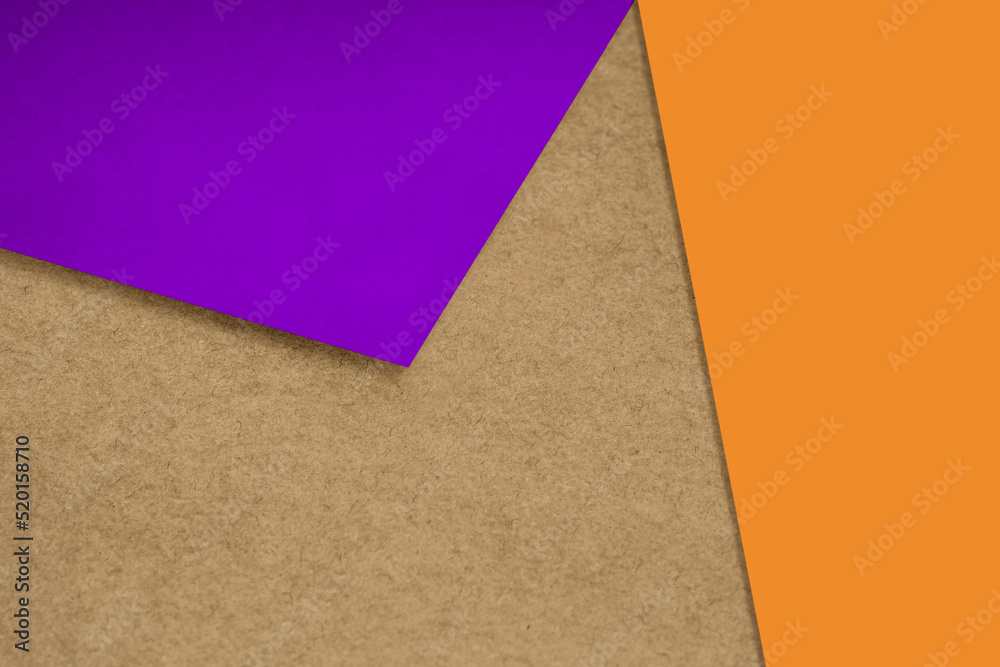 Fototapeta premium Plain and Textured pastel brown purple orange yellow papers randomly laying to form M like pattern and triangle for creative cover design idea