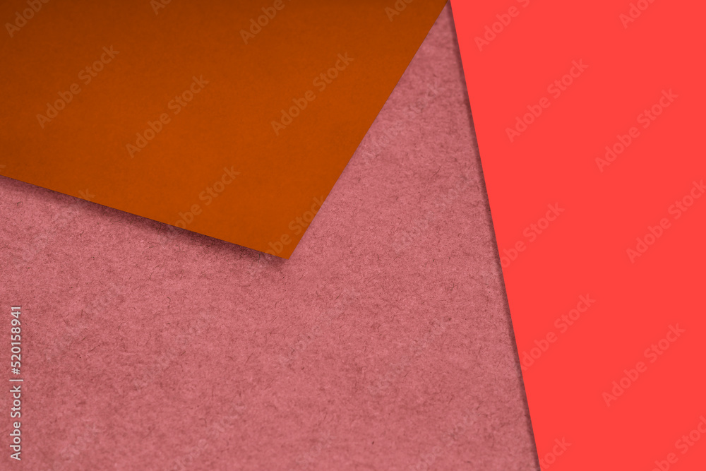 Plain and Textured neon pink orange brown papers randomly laying to form M like pattern and triangle for creative cover design idea Plain and Textured neon pink orange brown papers randomly laying to form M like pattern and triangle for creative cover design idea