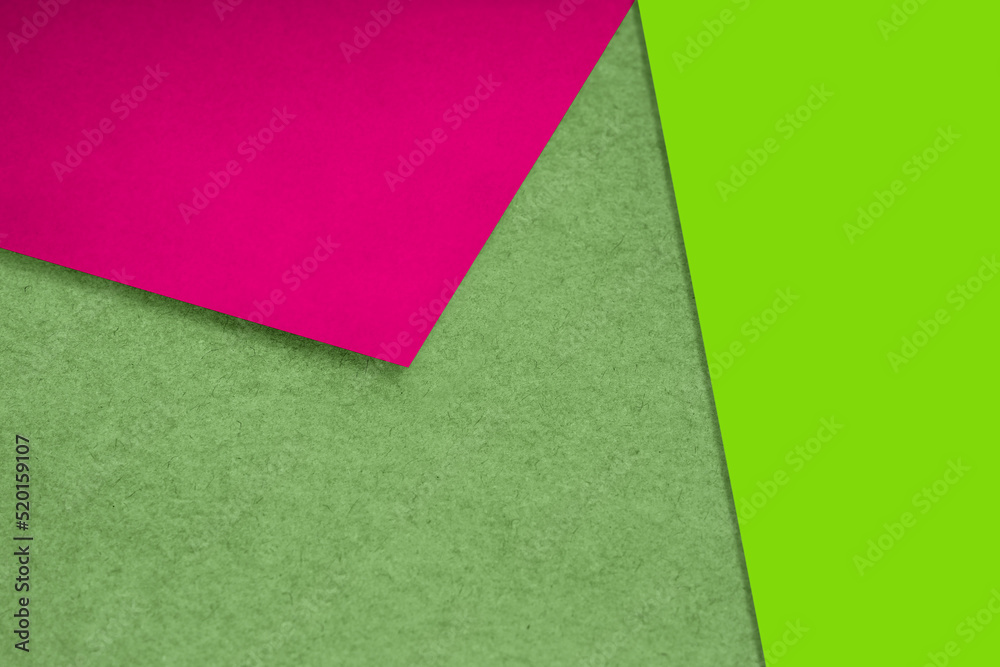 Plain and Textured neon green yellow pink papers randomly laying to form M like pattern and triangle for creative cover design idea Plain and Textured neon green yellow pink papers randomly laying to form M like pattern and triangle for creative cover design idea