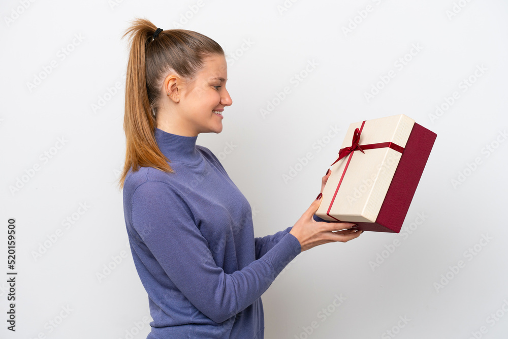 Young caucasian woman holding a gift isolated on white background with happy expression Young caucasian woman holding a gift isolated on white background with happy expression