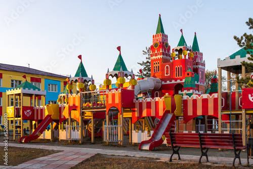 Children's playground in the form of the Moscow Kremlin. Red towers and fortress walls. Improvement in settlements of Russia. Urban-type settlement Palatka, Magadan region, Siberia, Russian Far East.