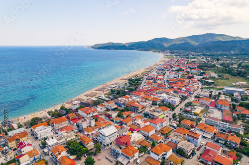 aerial drone shot of a famous village and long sandy beach of Sarti, Halkidiki, Greece. High quality photo