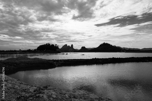 Landscpae of Mountain and Lake with Silhouette of People Working in Field in Lopuri Thailand