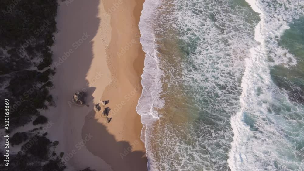 Drone flying over coastline with water seen rushing in Drone flying over coastline with water seen rushing in