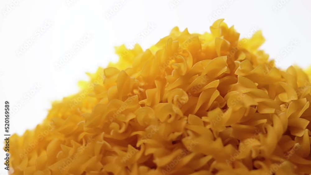 Uncooked Fusilli Pasta Heap Rotating against White Background. Fat and Unhealthy Food. Dry Spiral Macaroni. Italian Culture and Cuisine. Raw Golden Pasta Uncooked Fusilli Pasta Heap Rotating against White Background. Fat and Unhealthy Food. Dry Spiral Macaroni. Italian Culture and Cuisine. Raw Golden Pasta