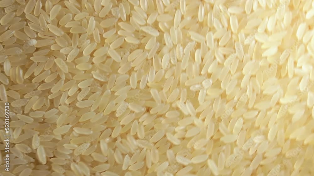 Dry Uncooked Parboiled Rice Background Rotating Clockwise - Top View. Scattered Raw Long Grain Rice. Asian Cuisine and Culture. Healthy Eating Ingredients. Diet Food. Angular Rotation Right Dry Uncooked Parboiled Rice Background Rotating Clockwise - Top View. Scattered Raw Long Grain Rice. Asian Cuisine and Culture. Healthy Eating Ingredients. Diet Food. Angular Rotation Right
