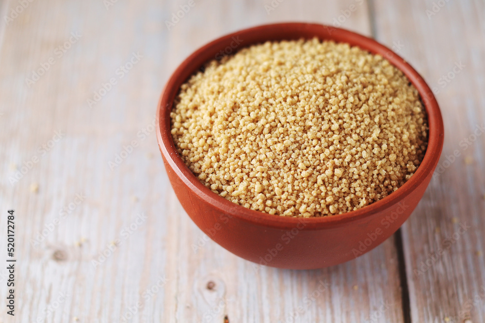 Dry couscous in a small ceramic bowl Dry couscous in a small ceramic bowl