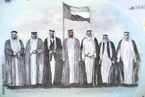 The seven founding fathers of UAE United Arab Emirates with flag after signing the union document from the obverse side of the new polymer commemorative 50 fifty Dirhams with Memorial to the martyrs photo