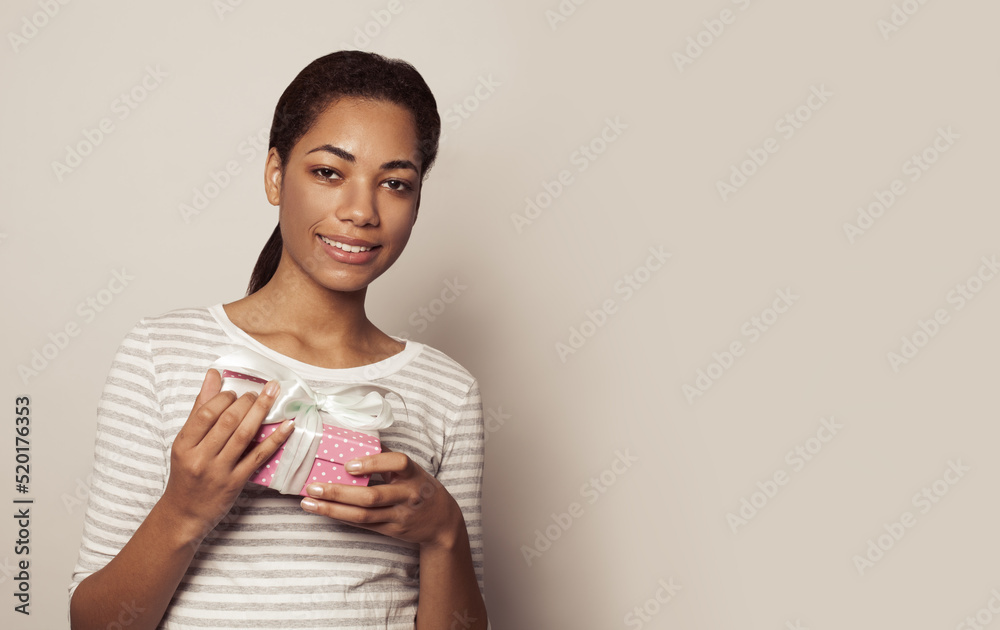 Pleasant black woman enjoying gift.
