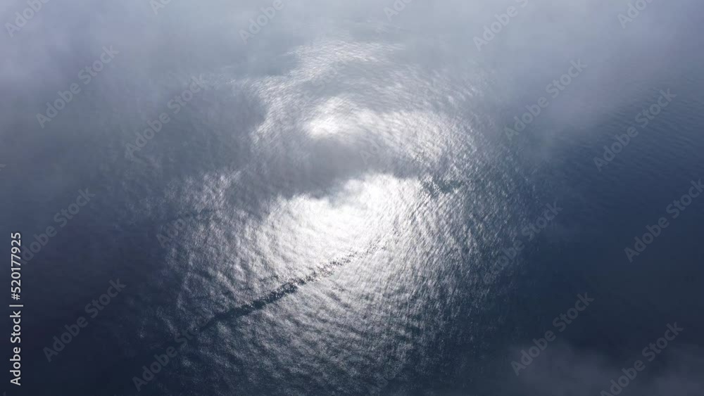 Aerial view. The drone flies over foggy and fluffy clouds. Blue sky sun and sea fog. Abstract aerial nature summer ocean sunset sea and sky background. Vacation, travel and holiday concept Aerial view. The drone flies over foggy and fluffy clouds. Blue sky sun and sea fog. Abstract aerial nature summer ocean sunset sea and sky background. Vacation, travel and holiday concept