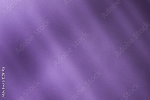 Illuminated light with gobo mask on purple background.