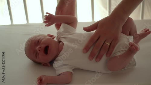 mother picking up and comforting her crying newborn baby