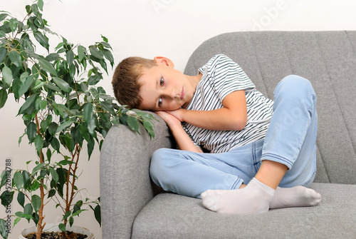 sad boy sitting on the couch