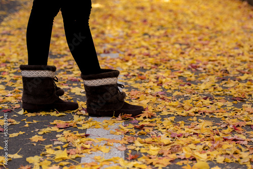 Close up of traveler woman feet on autumn season.