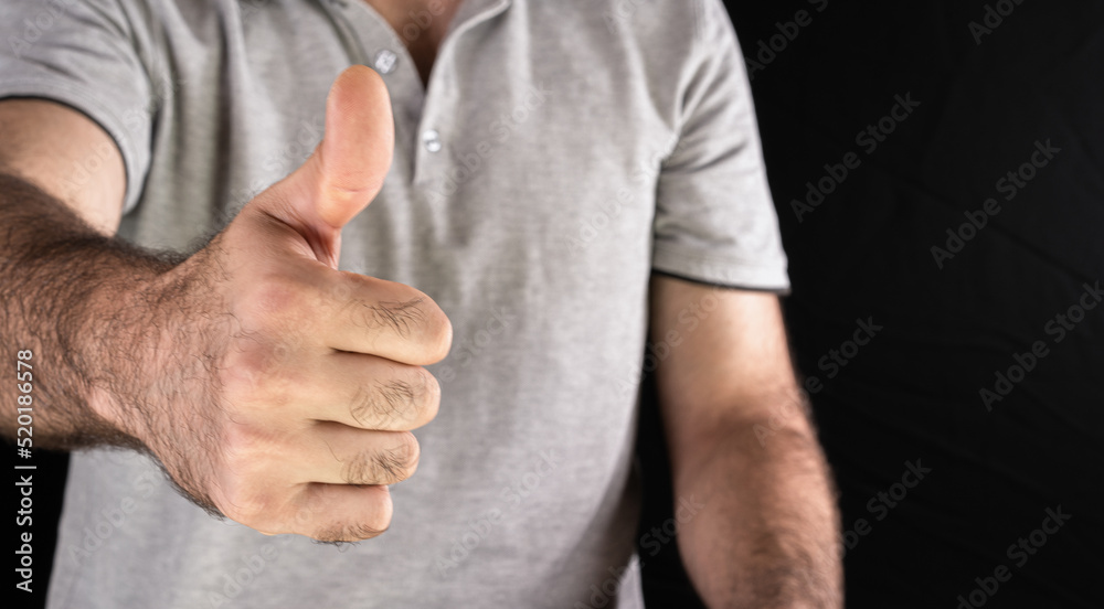 Man showing thumbs up in approval Man showing thumbs up in approval