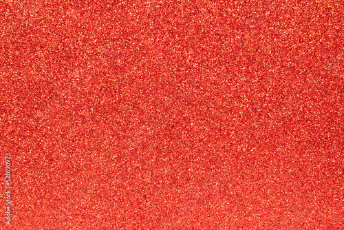 Red glitter background. Sparkling shiny wrapping paper texture wallpaper decoration.