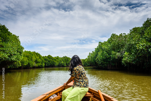 Young Indian woman boating through Pichavaram Mangrove Forests. The second largest Mangrove forest in the world, located near Chidambaram in Cuddalore District, Tamil Nadu, India photo