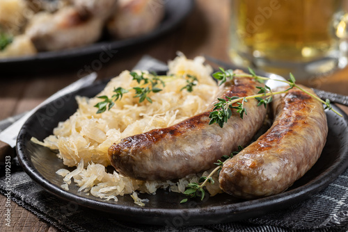 Grilled bratwurst and sauerkraut meal photo
