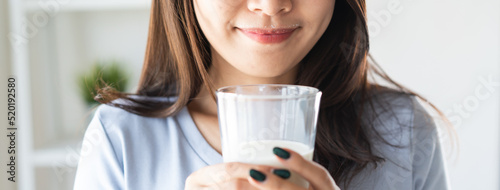 Close up view of asian woman drinking milk.