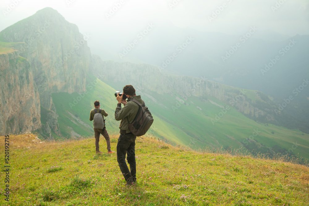 Photographer taking picture with a digital camera in nature.
