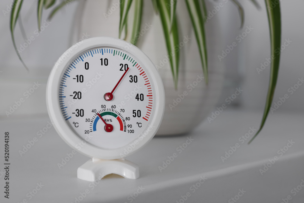Round mechanical hygrometer on white table indoors. Space for text - obrazy, fototapety, plakaty 