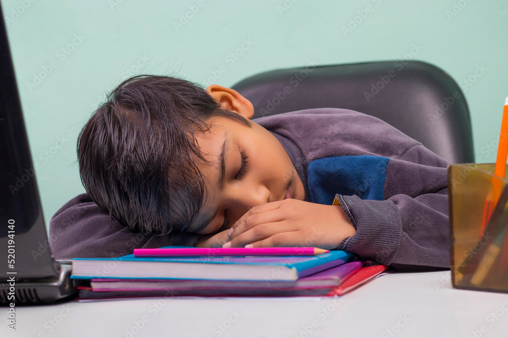 a boy laying down on table and Sleeping a boy laying down on table and Sleeping