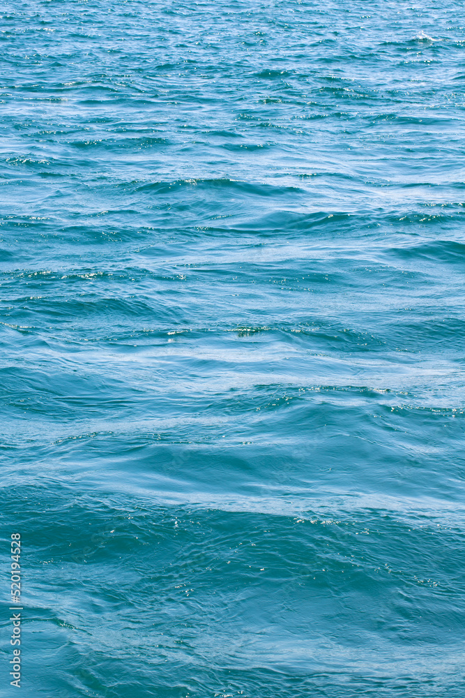Fototapeta premium Sea surface. Turquoise sea water. Close up blue water surface at deep ocean
