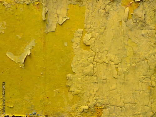Rusted yellow painted metal wall .close up