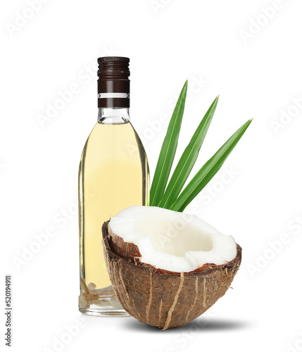 Bottle of coconut cooking oil and fruit on white background